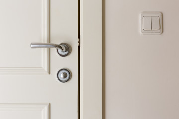 Obraz premium open and closed white doors close up of handle and keyhole