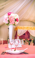 Beautiful flowers and  serving on table for the wedding day