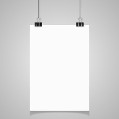 Blank white page hanging against grey background
