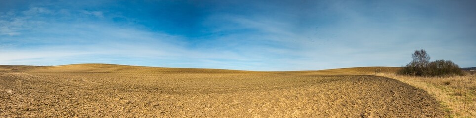 Early springtime plowed field landscape - 104790658
