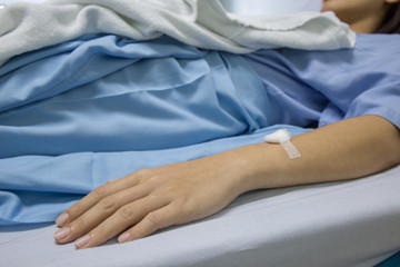 Close up of patient's hand with iv solution set.