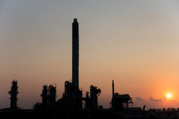 Silhouette Process Columns of Natural Gas Plant with morning sunrise background