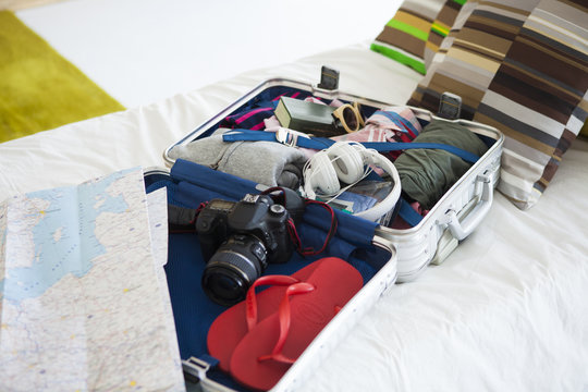 Suitcase which is spread on the bed