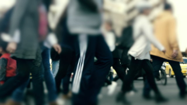 People pedestrians walk/cross big city intersection slow motion 100p.Gimbal stabilized tracking shot of an anonymous crowd 