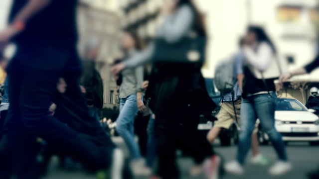 People pedestrians walk/cross big city intersection slow motion 100p.Gimbal stabilized tracking shot of an anonymous crowd 