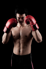 Fototapeta na wymiar Muscular Asian man with red boxing glove