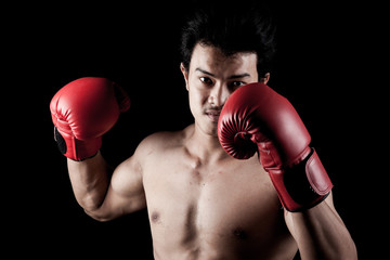 Fototapeta na wymiar Muscular Asian man with red boxing glove