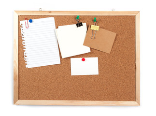 Cork board with several blank notes with pins on white backgroun