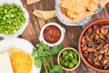 Ingredients for homemade nachos. Bowl with mixed beef and pinto beans.