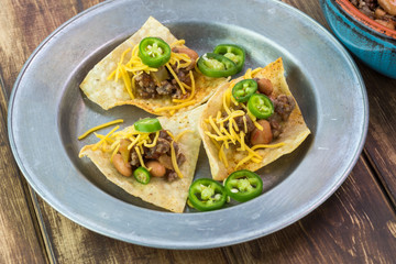 Homemade nachos with beef and pinto beans - ready to bake.