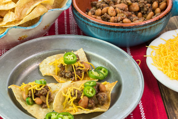 Homemade nachos with beef and pinto beans - ready to bake.