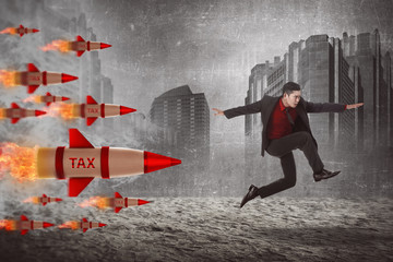 Asian business man jump from tax rocket