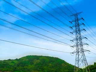 electric high power stand on green hill and blue sky