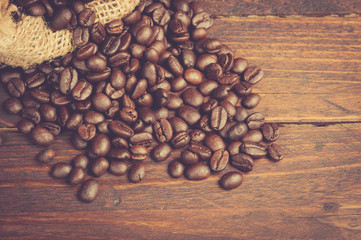 Coffee beans on wooden table,vintage color toned image