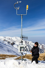 The meteorologist working at a weather station in the mountains - obrazy, fototapety, plakaty