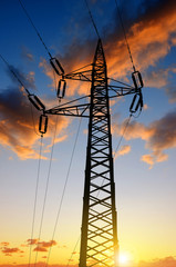 High voltage towers against the sunset