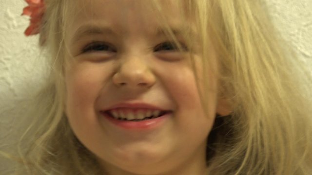 Closeup of Happy Baby Girl Grimace She's Face. 4K UltraHD video.