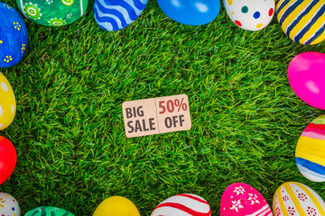 Easter eggs Sale Coupon, voucher, tag on Fresh Green Grass