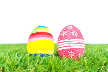 Easter Eggs on Fresh Green Grass over white background