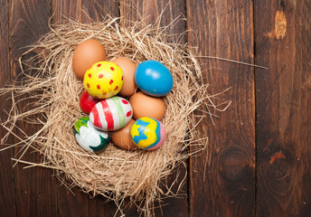Easter eggs and hay on wooden background,morning light