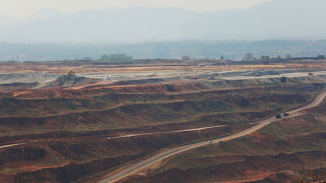 Mining dump trucks working in Lignite coalmine lampang thailand 