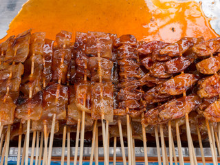 Grilled squid and fish on stick with sauce, Thailand street food.