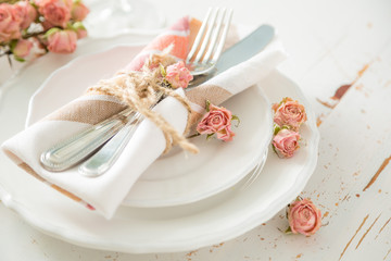 Romantic table setting with died flowers