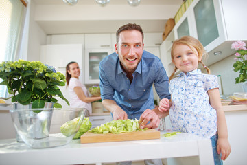 Familie bereit Mittagessen mit Salat vor