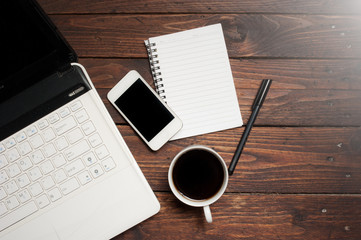 Office desk with laptop computer, notebook, mobile smartphone 