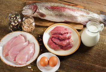 Food high in protein on a rustic wooden table.