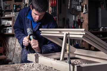 Carpenter using Hammer and Chisel in Workshop