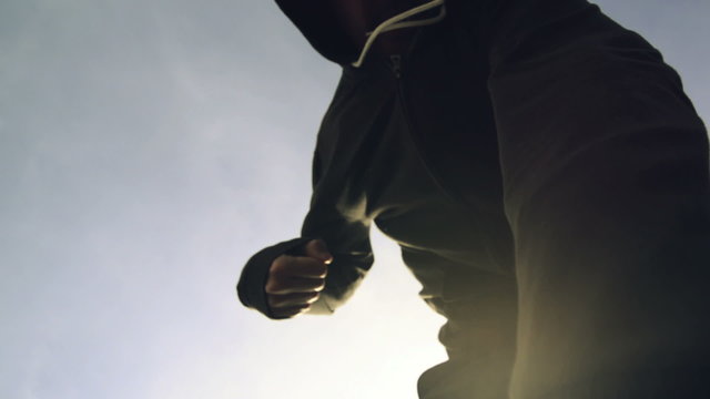 Being punched and mugged by aggressive violent man in hooded jacket on street, victim's pov perspective footage.