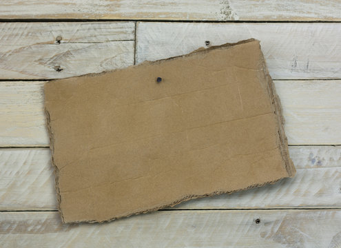 Cardboard sign on a wooden background