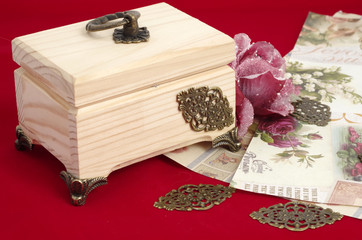 Making decoupage jewelry box - tools and materials on red velvet background