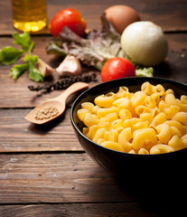 macaroni pasta spaghetti, vegetables and spices on wood,morning