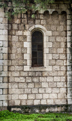 Fototapeta na wymiar Arched window in the stone wall, Jerusalem