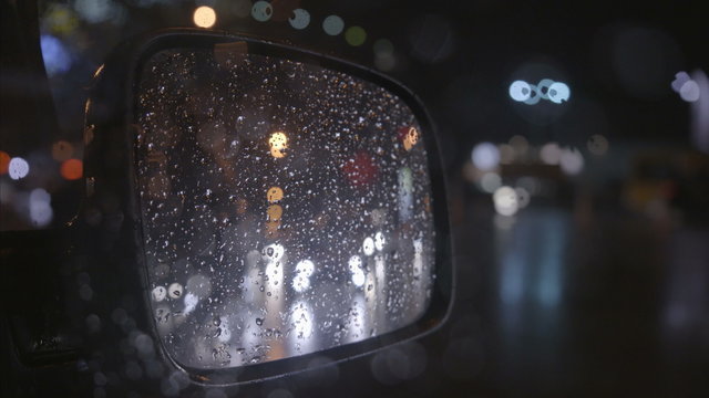 2 in 1 video! The reflection of the rainy city in the right mirror of a car. Evening-night time, real time capture