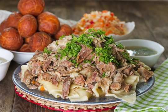 National Kazakh dishes: Beshbarmak, salad of radish Shalgam, and Baursak.