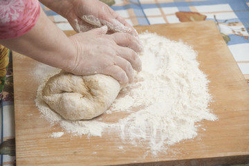 Women's hands prepairing fresh yeast dough