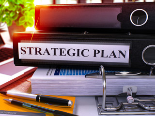 Strategic Plan - Black Ring Binder on Office Desktop with Office Supplies and Modern Laptop. Strategic Plan Business Concept on Blurred Background. Strategic Plan - Toned Illustration. 3D Render. © tashatuvango