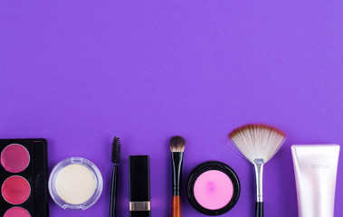 cosmetics brush lipstick shade on a purple background
