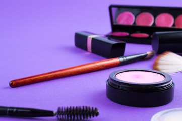 Obraz na płótnie Canvas cosmetics brush lipstick shade on a purple background