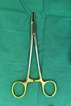 Detail shot of steralized surgery instruments with a hand grabbing a tool