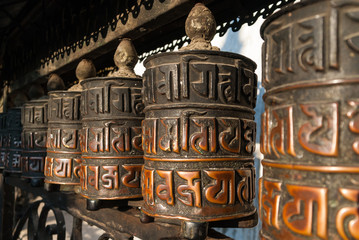 A row of Buddhist prayer wheels in Kathmandu, Nepal