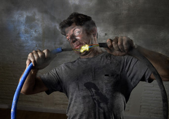 untrained man joining cable suffering electrical accident with dirty burnt face shock expression