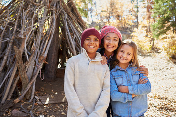 Group Of Children Playing In Forest Camp Together