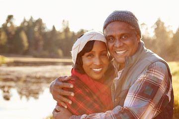 Portrait Of Senior African American Couple Walking By Lake