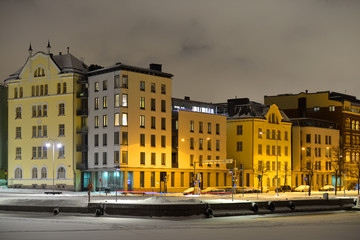 North Quay is located in center. On waterfront there are houses built in different architectural styles in different historical periods. View of embankment winter night
