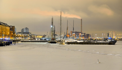 Yachts and boats cold winter evening in Northern harbor in Helsinki