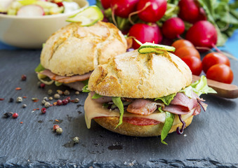 Sandwiches with bacon, cheese, salad and rustic bread